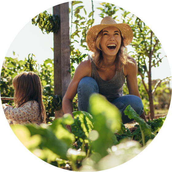 Happy woman gardening with child.